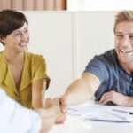 Factory Credit Counseling - Two Persons Handshaking With Happy Faces