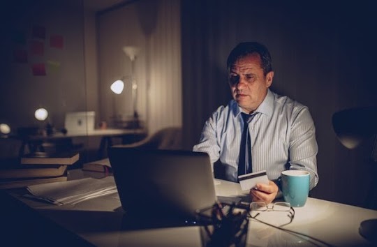 Credit Card Settlement Expertise - Lotus Advisory UAE Settling Credit Card Debt - A Person Filling Credit Card Details in Laptop